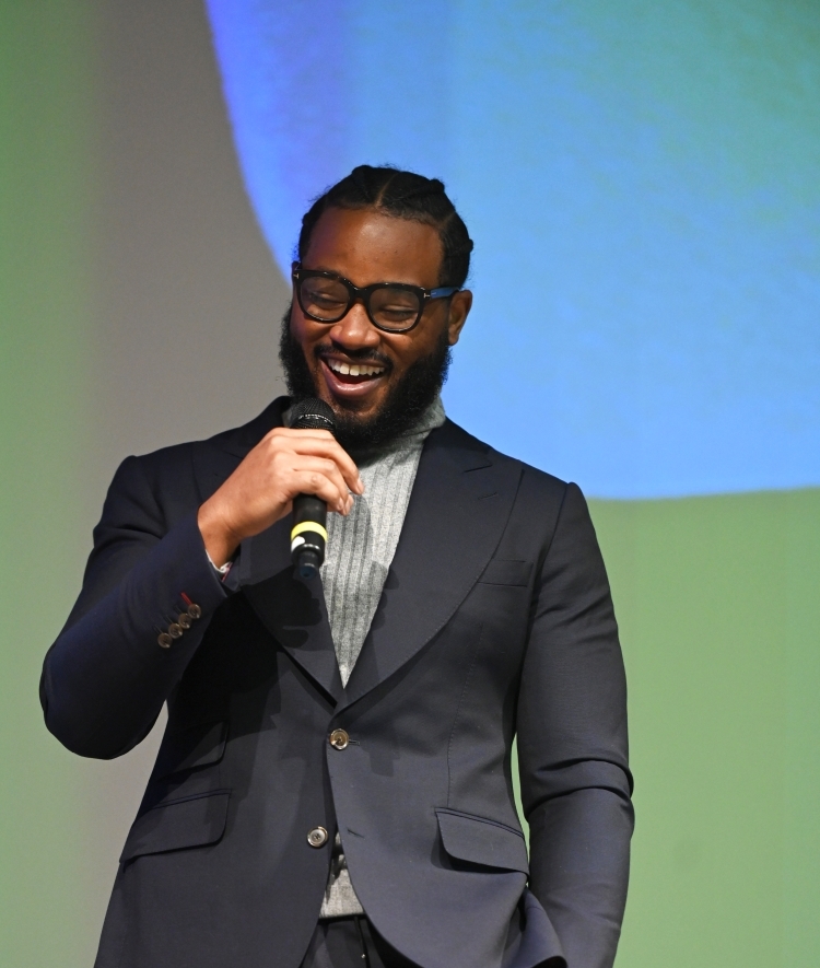 Ryan Coogler holds microphone on stage at Sundance Film Festival