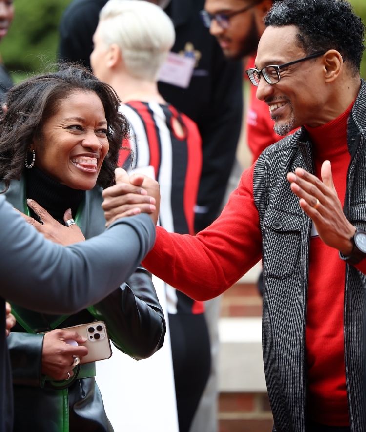BSC celebration three people smiling and greeting each other