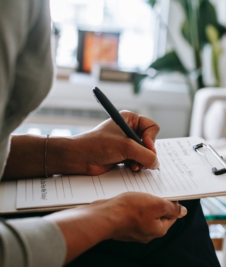 Therapist Taking Notes on Clipboard