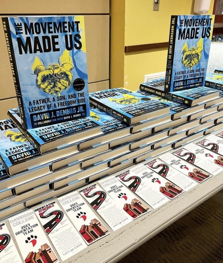 a table covered with copies of the book, "The Movement Made Us"