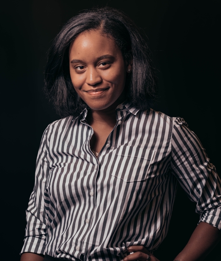 a young Black woman wearing a striped shirt