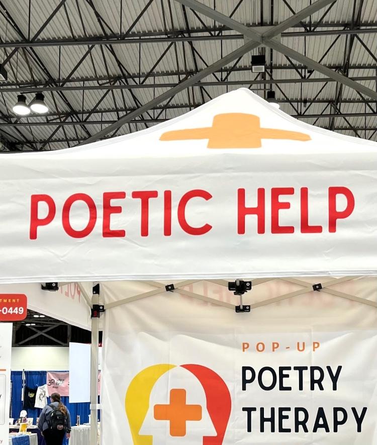 a white tent that reads "poetic help"