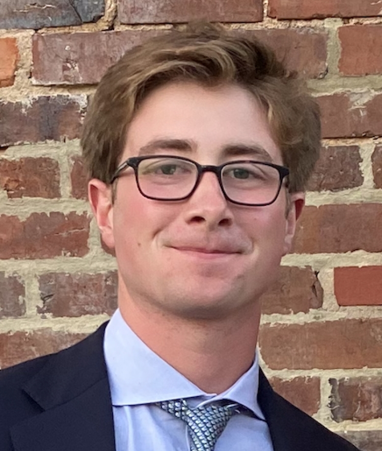 a young white man wearing a suit and tie