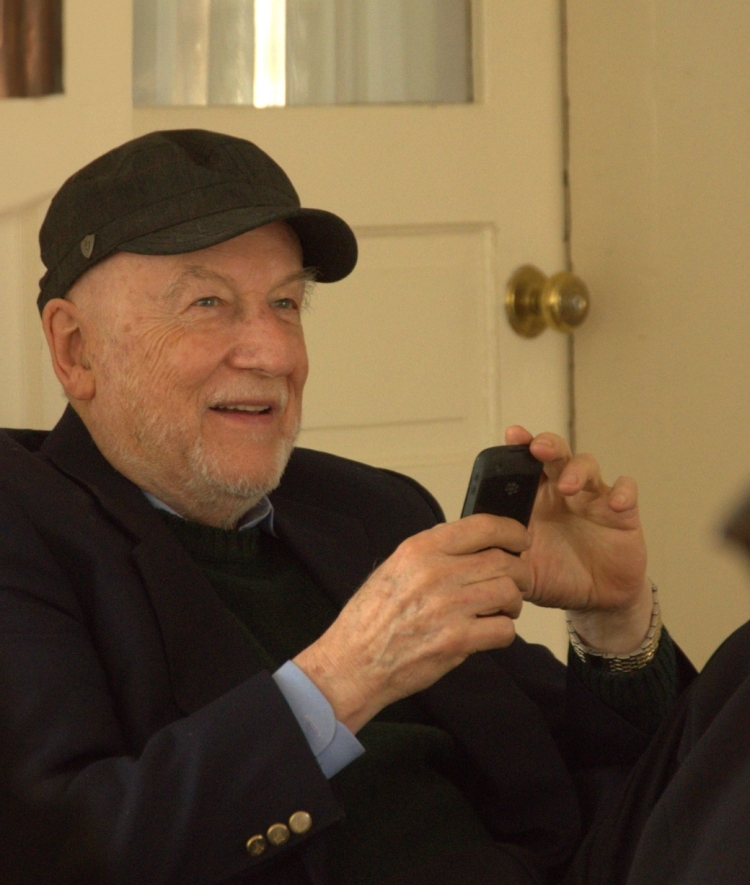 an older white man wearing a suit and hat