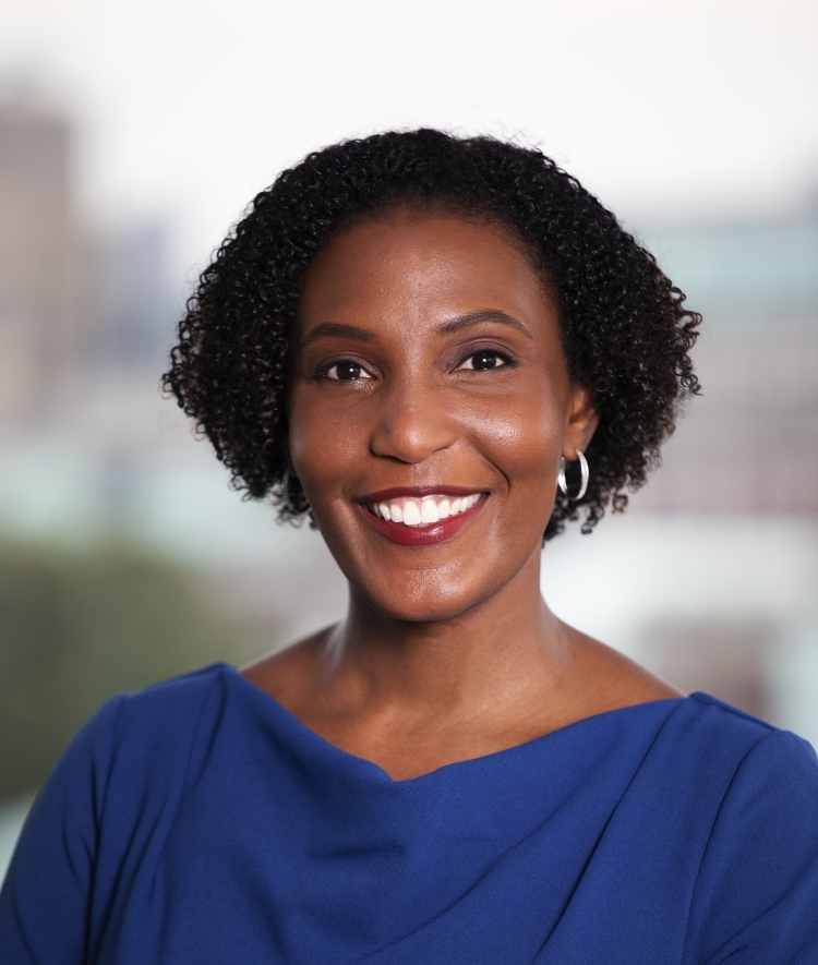 a middle aged Black woman wearing a blue top