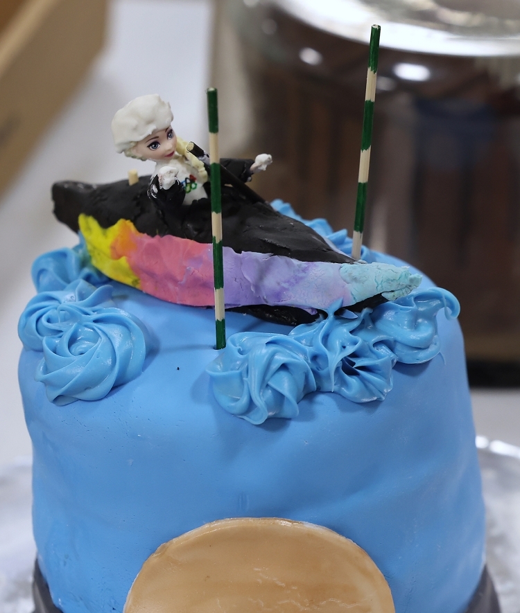 a cake with a young woman kayaking on it