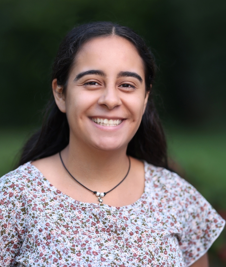 a young woman wearing a floral top