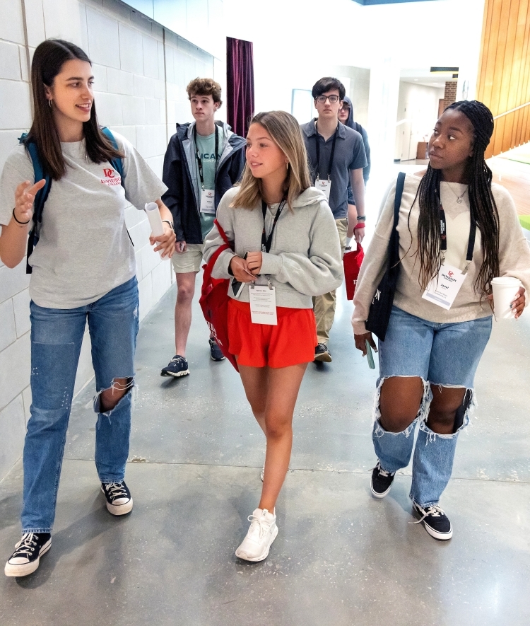 a group of students walk together in an academic hallway