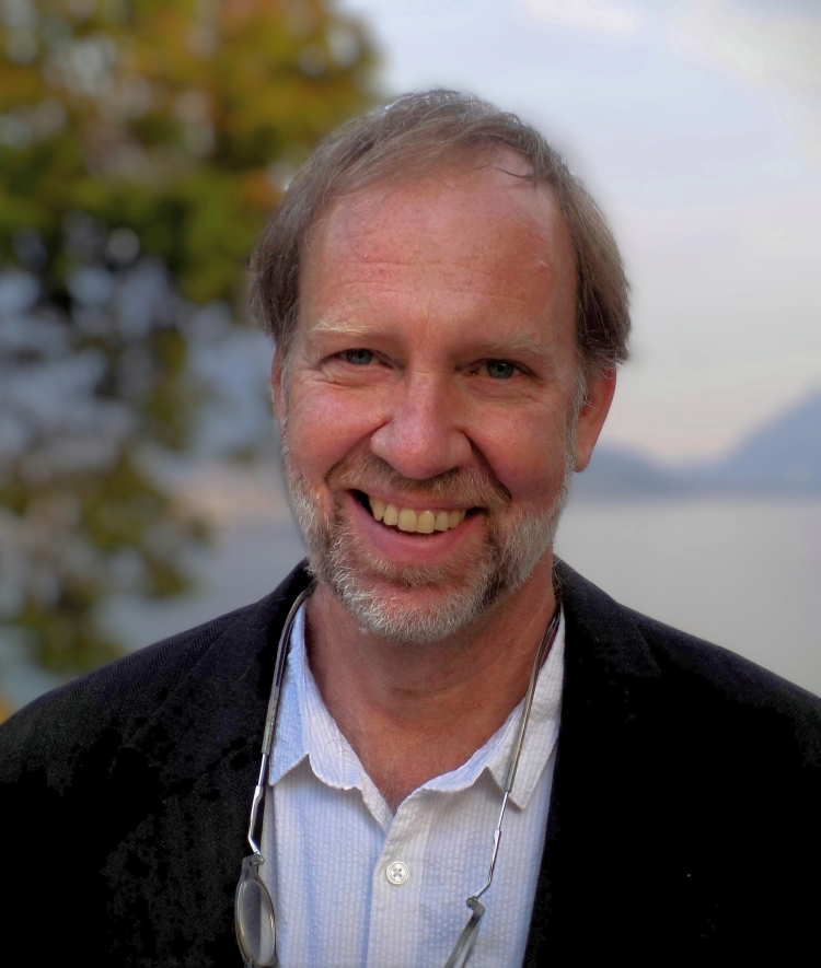 a middle aged white man wearing a collared shirt and sports jacket