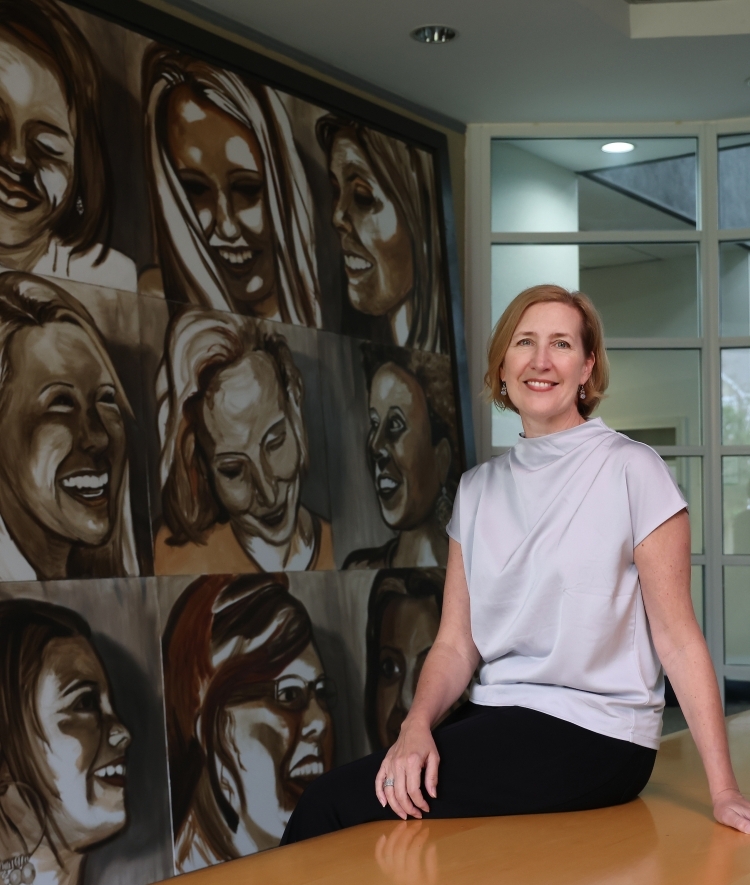YWCA's Kirsten Sikkelee in front of painting