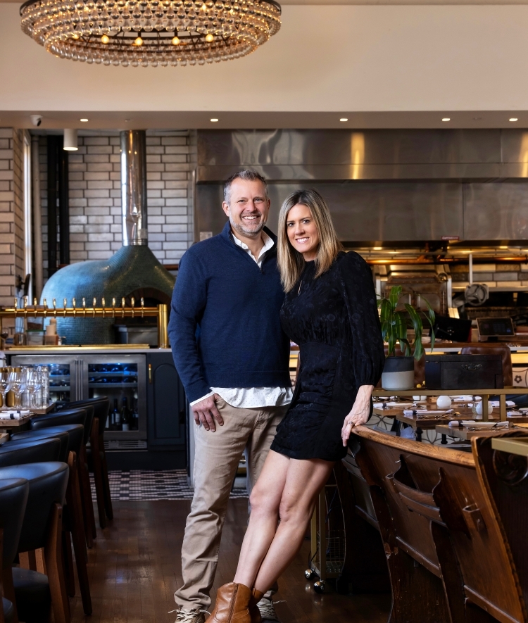 a young couple stands together in a restaurant