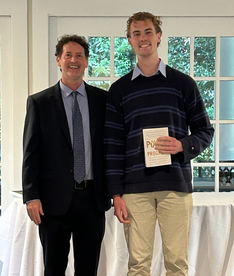 a young man and his professor smiling