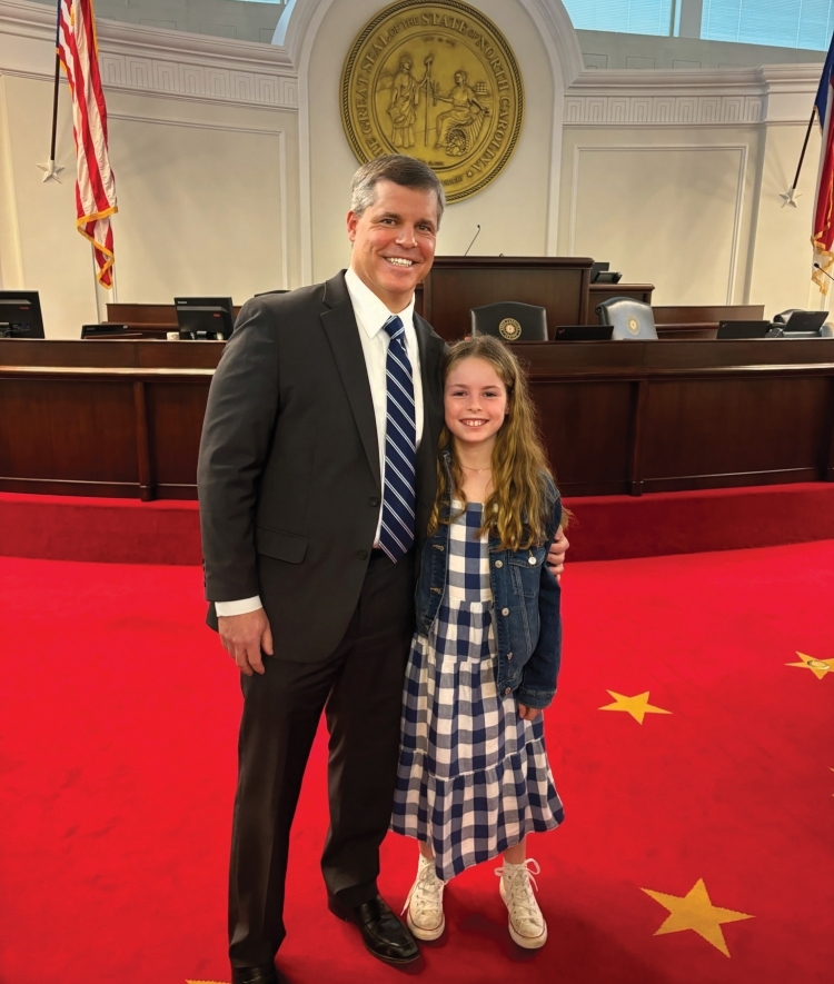 a middle aged white man with his daughter in a political building