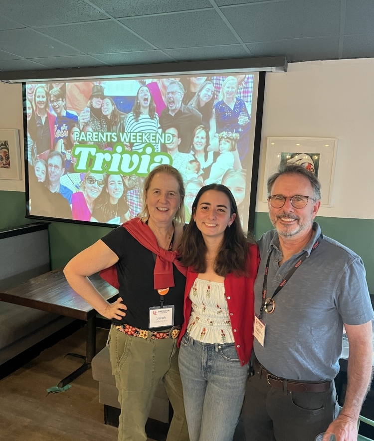 a young woman with her parents in a coffee shop