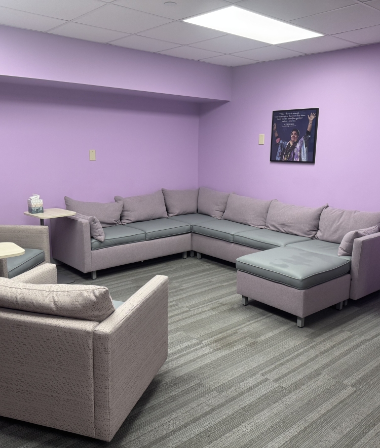 a purple painted room with comfy couches and chairs
