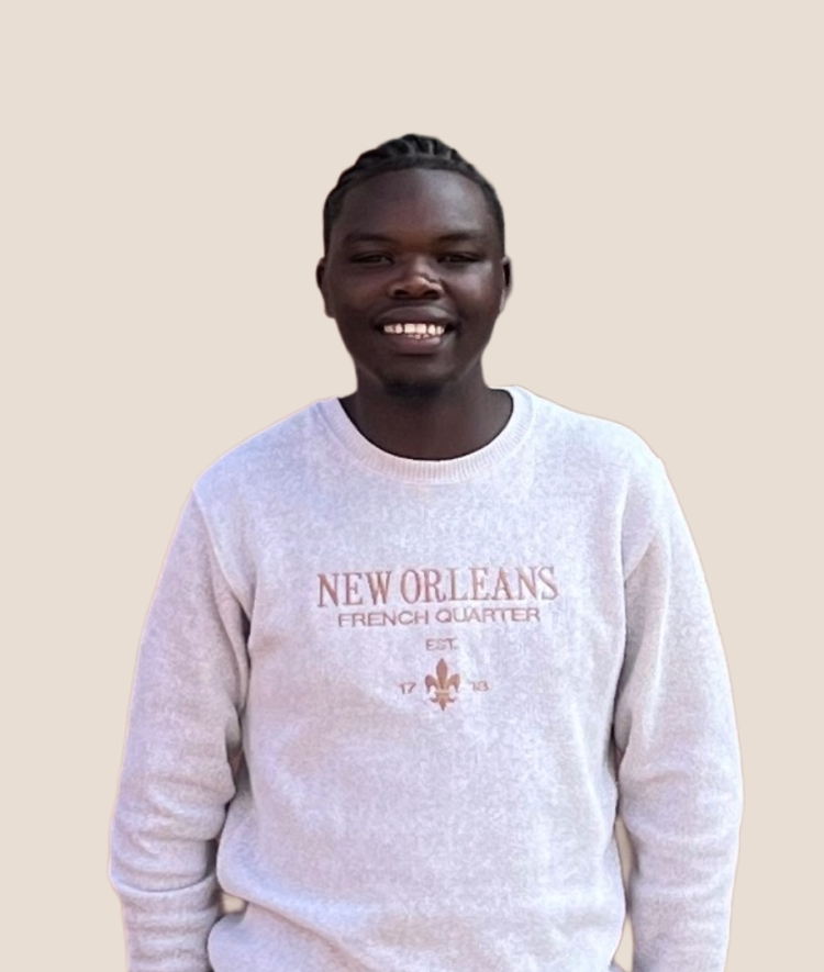 a young man wearing a "New Orleans French Quarter" sweatshirt on a beige background