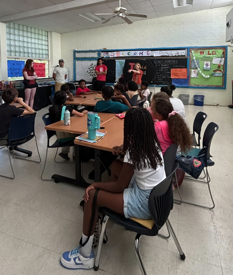 Nora Fenn Gilman ’26 and volunteers in classroom teaching students