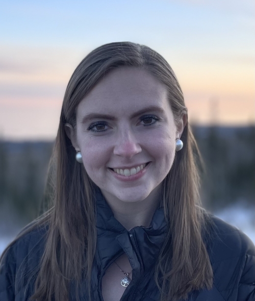 A white woman with brown hair smiling