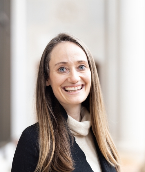 a young woman with light brown and blonde hair and a turtleneck