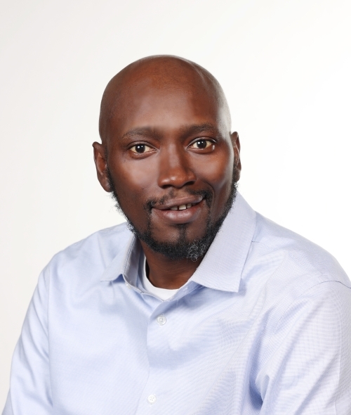 a middle aged Black man wearing a white collared shirt