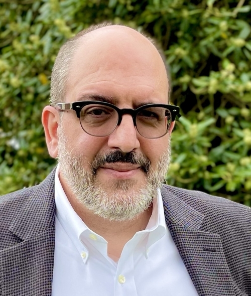 an older man wearing a jacket and glasses