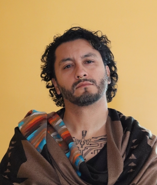 a young man with black curly hair