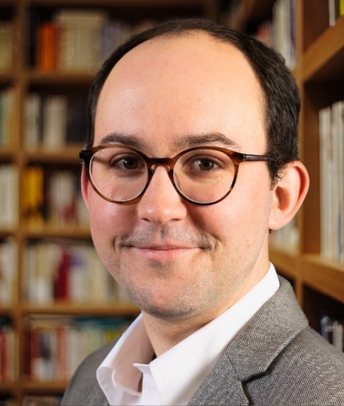 a middle aged white man wearing glasses