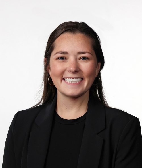 a young white woman wearing a black blazer with brown hair