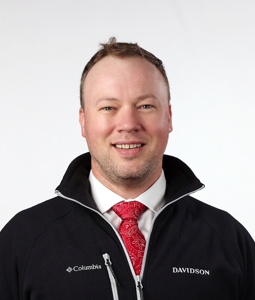 a young white man wearing a tie and jacket