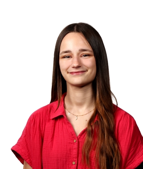 a young white woman wearing a red top with long brown hair