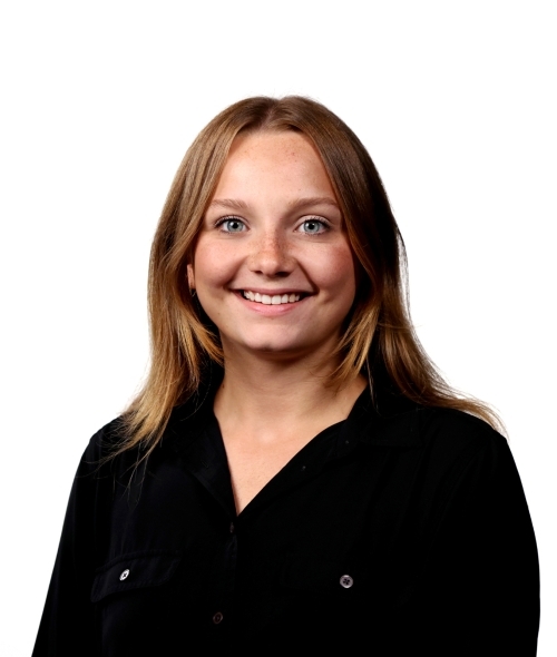 a young white woman with blonde hair wearing a black top