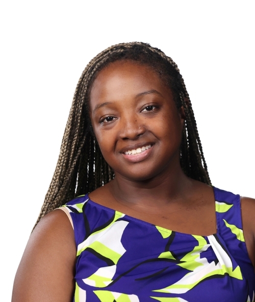 a young Black woman wearing a blue and green top with long black hair