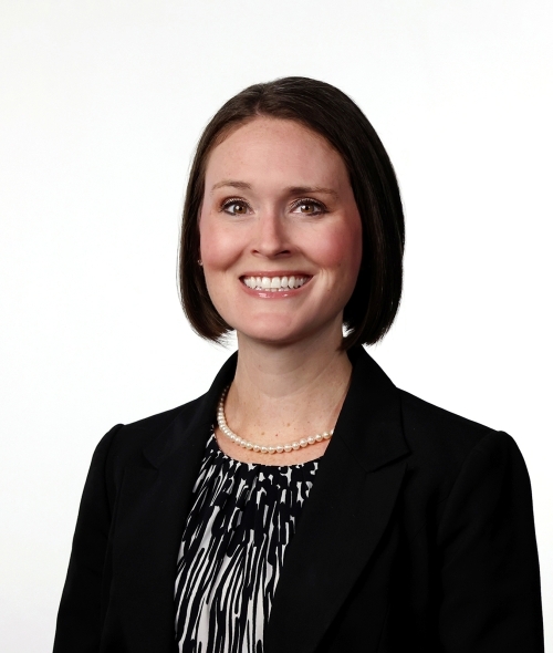 a young white woman with short brown hair wearing a black blazer