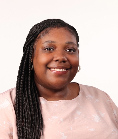 a young Black woman wearing a pink top