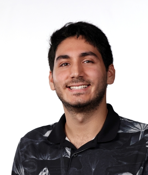 a young man with dark brown hair smiling