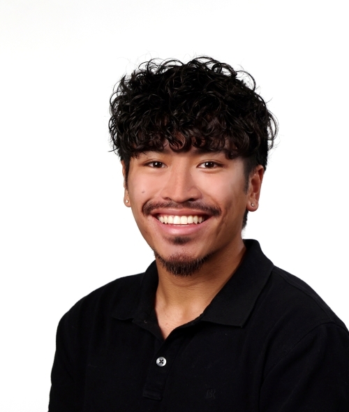 a young man wearing a black collared shirt with black hair