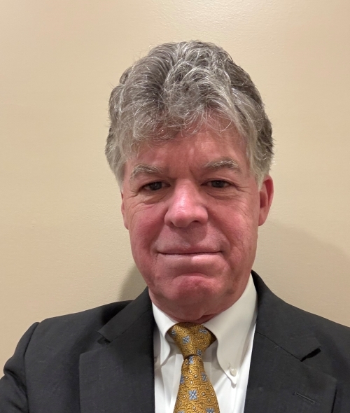 an older white man with grey hair wearing a suit and tie