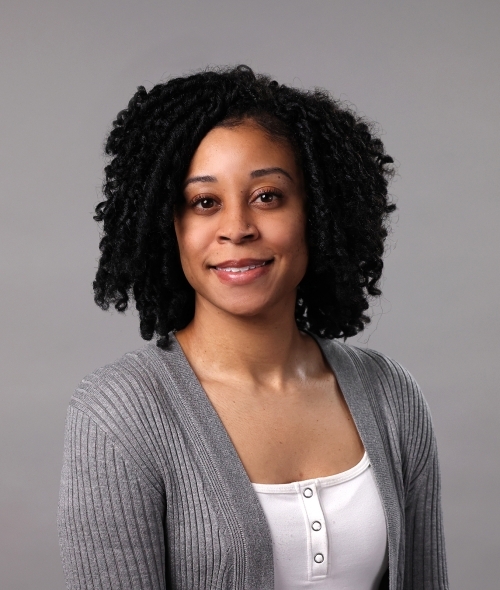 Erica Calhoun wearing a white camisole and grey cardigan