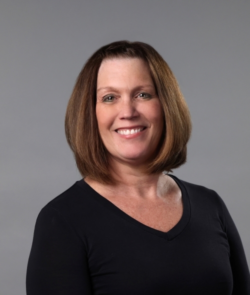 a middle aged white woman wearing a black top with a bob haircut