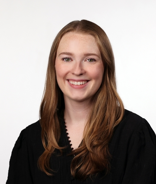 a young white woman with dirty blonde hair wearing a black top