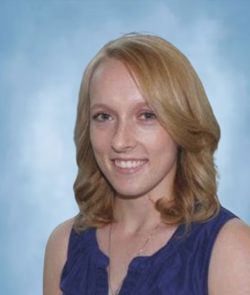 a young white woman with strawberry blonde hair wearing a blue top