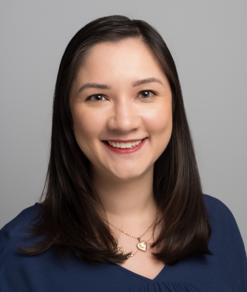 a young Asian woman with dark brown hair wearing a navy blue top