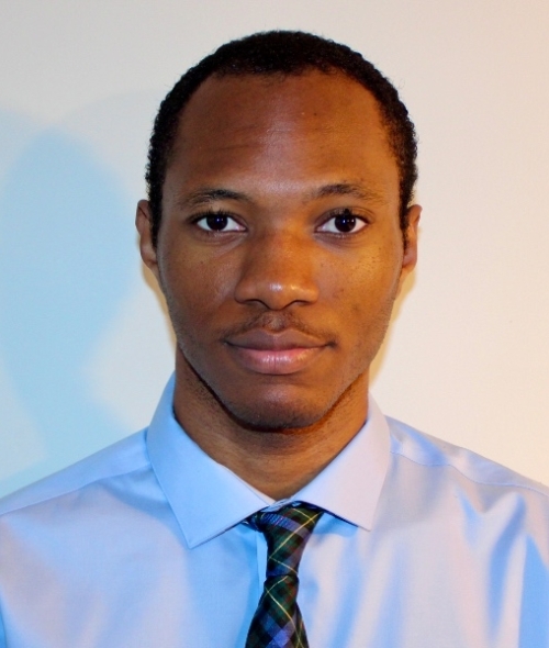 a young man with dark hair wearing a tie and collared shirt