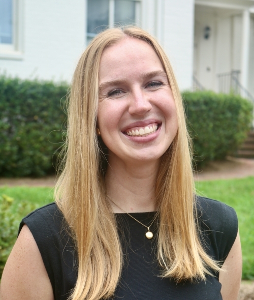 a young woman with blonde hair wearing a black top