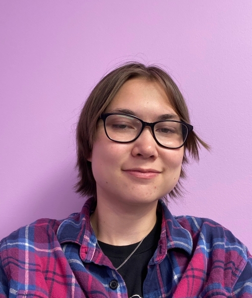 a young person wearing a flannel shirt and glasses on a purple background