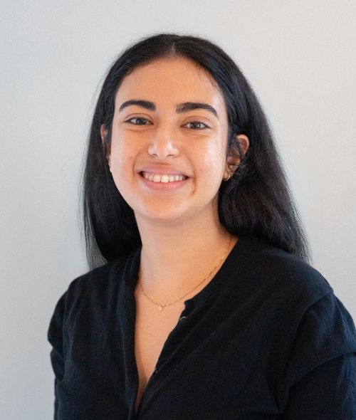 A young woman with long dark hair, a smiling expression and a black blouse