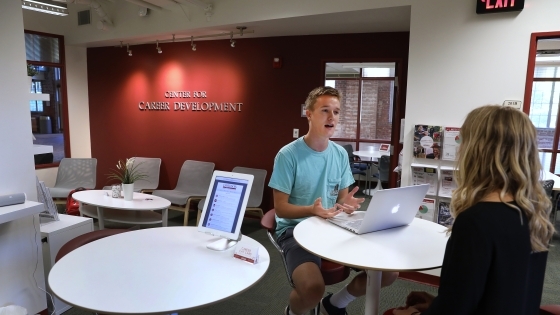 Student sits with career counselor to discuss job opportunities