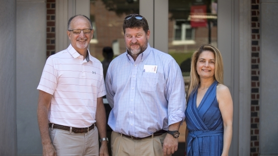 Scott Applegate, David Holthouser and Irsa Vargas pose on the steps of Chambers