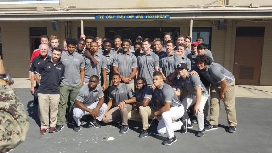 Football Team Poses for Photo at Naval Base