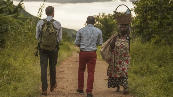 Ross Boyce with people from Uganda walking to water